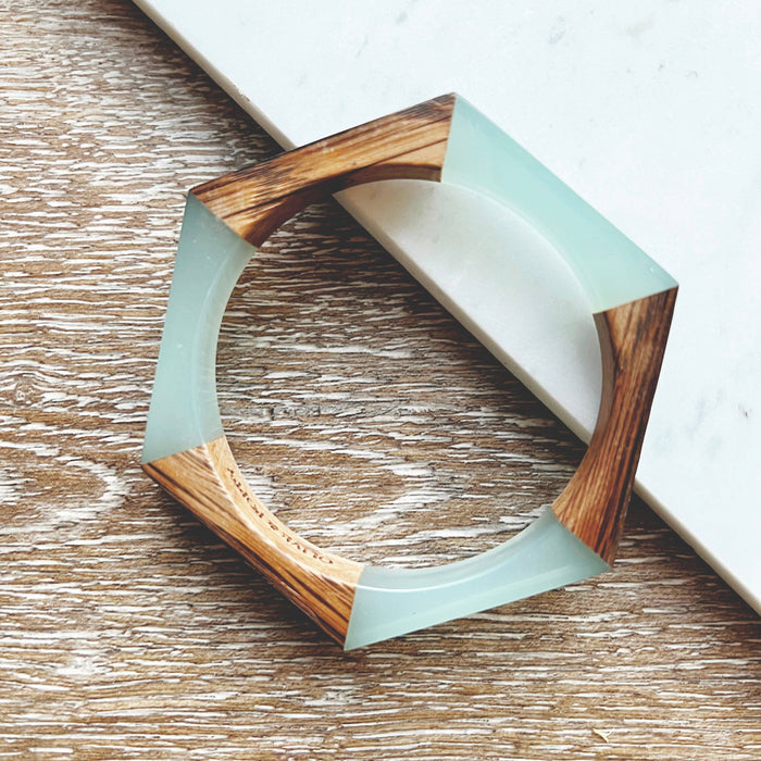 Olive and Poppy 1/2-inch barrel bracelet featuring textured metal links on a neutral background
