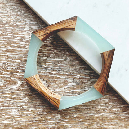 Olive and Poppy 1/2-inch barrel bracelet featuring textured metal links on a neutral background