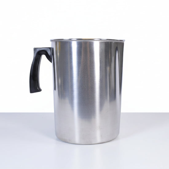 Silver pitcher with a black handle on a white background