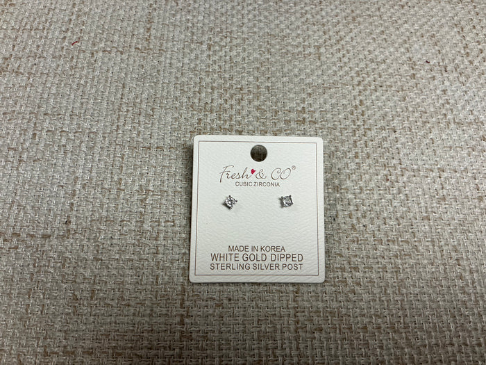 SM Style cubic zirconia stud earrings with sparkling clear stones set in silver-tone metal on a white background.