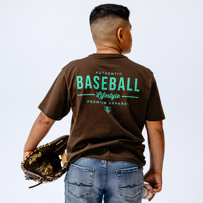 Child wearing a brown 'Baseball Lifestyle' t-shirt with a baseball glove on a light blue background