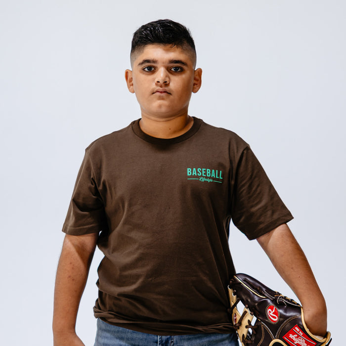 Person wearing a brown 'Baseball Lifestyle' t-shirt holding a baseball glove