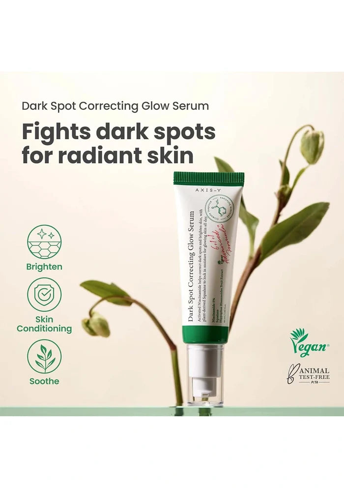 A tube of Dark Spot Correcting Glow Serum with plant elements on a light background