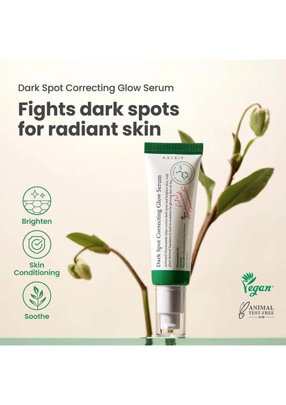 A tube of Dark Spot Correcting Glow Serum with plant elements on a light background