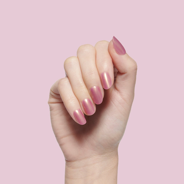 Baby Starfish | Round | Extra Short coral iridescent press-on nails in a round shape for a quick at-home mani look