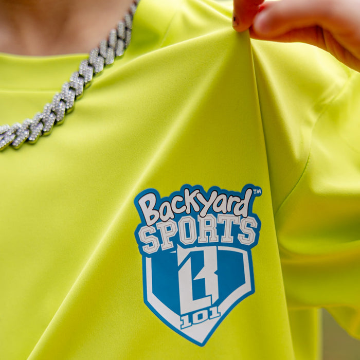 Yellow shirt with 'Backyard Sports BL101 101' logo held by a person