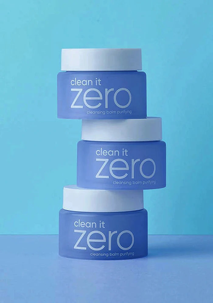 Stack of 'clean it zero' skincare products on a blue background