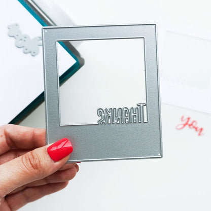 Catherine Pooler - Dies - Instant Thanks. Inspired by the classic Polaroid are the Instant Happy and Instant Thanks Dies. These versatile dies can be used in so many ways! With the secondary dies, you can cut the word out of the frame for another look. Illustrated by Leslie Dunegan. Stainless steel and are compatible with all standard die cutting machines. Available at Embellish Away located in Bowmanville Ontario Canada.