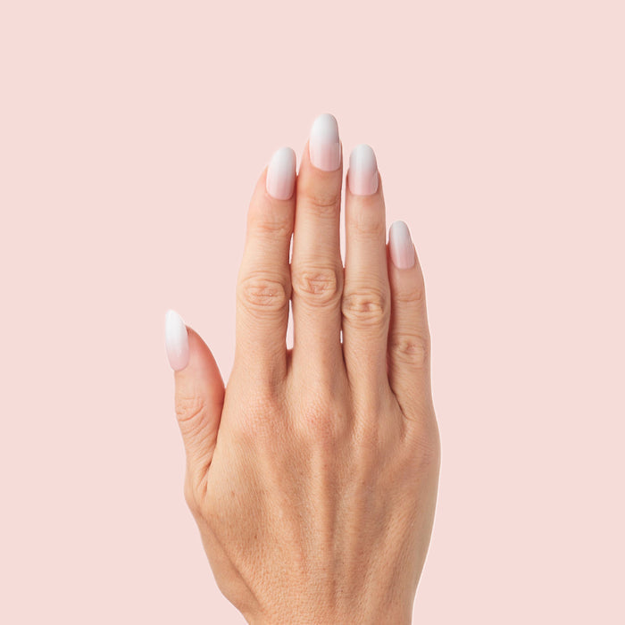 CCT Gradient - Press-On | Short | Round hand with white to sheer pink gradient short round false nails on pink background