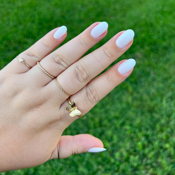 CCT Gradient - Press-On | Short | Round hand with short round false nails fading white to sheer pink against green grass background