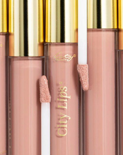 City Lips Pink Nude opaque lipgloss in clear tube, showcasing smooth, shiny finish and natural nude pink color on lips.