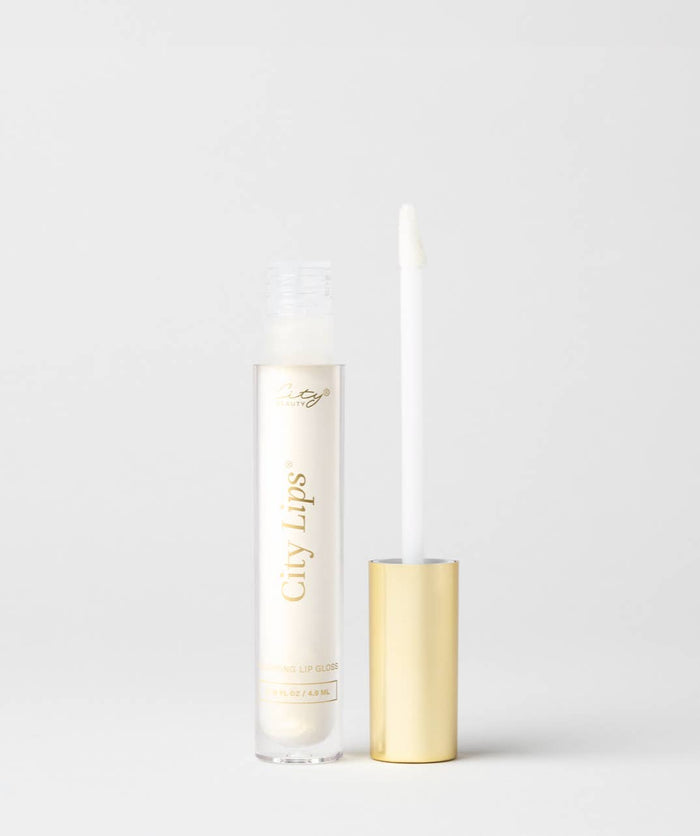 City Lips Midnight Sparkle gold glitter lip gloss applied on lips, showcasing shimmering gold glitter finish and smooth texture.