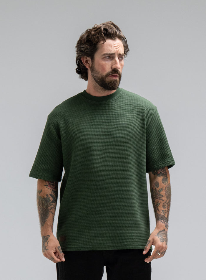 Max Is 5ft 8" And Wears Size: M | Hem Studio Image Of Model Wearing Dissident Waffle Short Sleeve T-Shirt In Forest Green (SS Model)