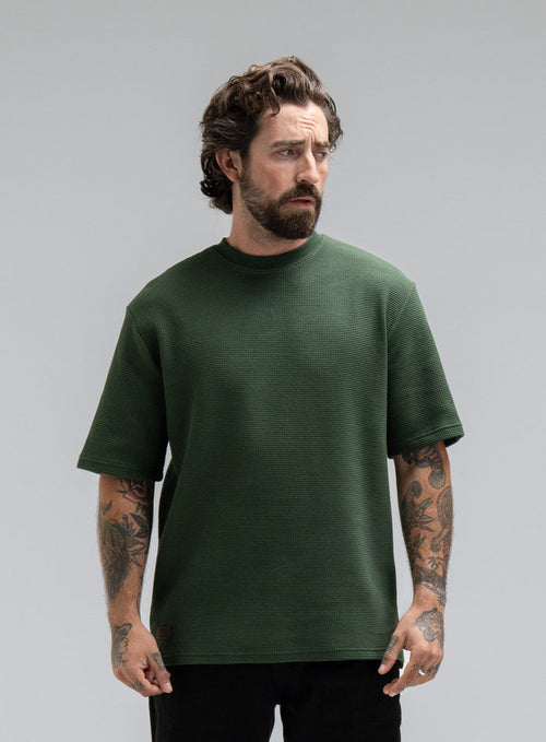 Max Is 5ft 8" And Wears Size: M | Hem Studio Image Of Model Wearing Dissident Waffle Short Sleeve T-Shirt In Forest Green (SS Model)