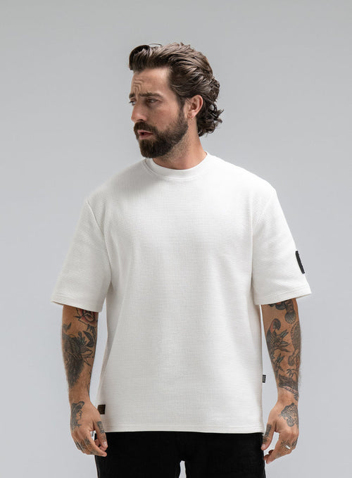 Max Is 5ft 8" And Wears Size: M | Hem Studio Image Of Model Wearing Dissident Waffle Short Sleeve T-Shirt In Optic White (SS Model)