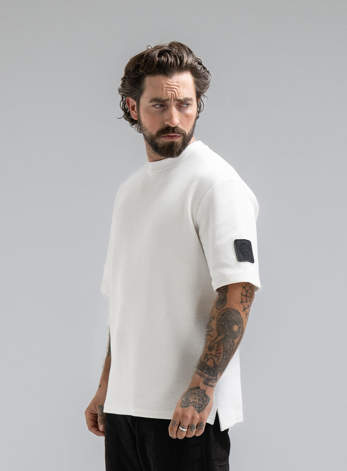 Max Is 5ft 8" And Wears Size: M | Hem Studio Image Of Model Wearing Dissident Waffle Short Sleeve T-Shirt In Optic White (SS Model)