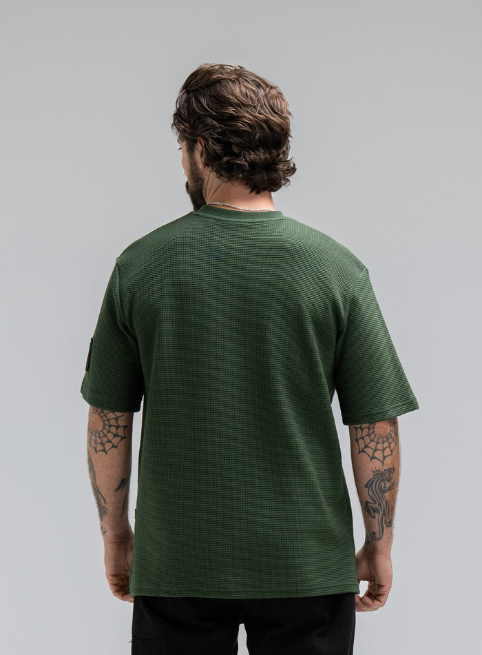 Max Is 5ft 8" And Wears Size: M | Hem Studio Image Of Model Wearing Dissident Waffle Short Sleeve T-Shirt In Forest Green (SS Model)