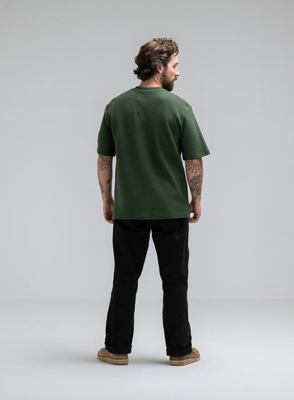Max Is 5ft 8" And Wears Size: M | Hem Studio Image Of Model Wearing Dissident Waffle Short Sleeve T-Shirt In Forest Green (SS Model)