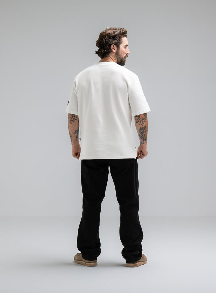 Max Is 5ft 8" And Wears Size: M | Hem Studio Image Of Model Wearing Dissident Waffle Short Sleeve T-Shirt In Optic White (SS Model)