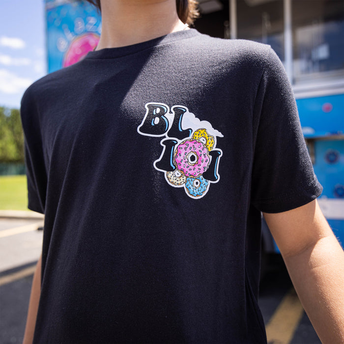 Youth model wearing black youth graphic tee with “Donut Truck” design