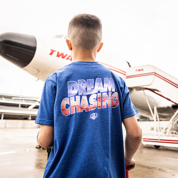 Youth model wearing blue Dream Chaser Sunrise youth graphic tee