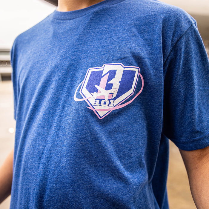 Youth model wearing blue Dream Chaser Sunrise youth graphic tee