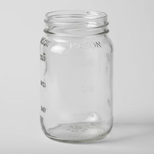 Clear glass mason jar on a white background