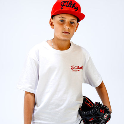Child wearing a white t-shirt with 'Baseball' text and a red cap with 'Filthy' text, holding a baseball glove.