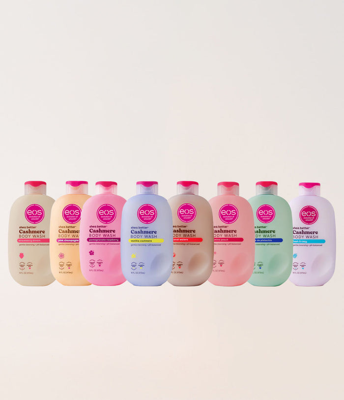 Row of eos Cashmere Body Wash bottles in various colors on a light beige background