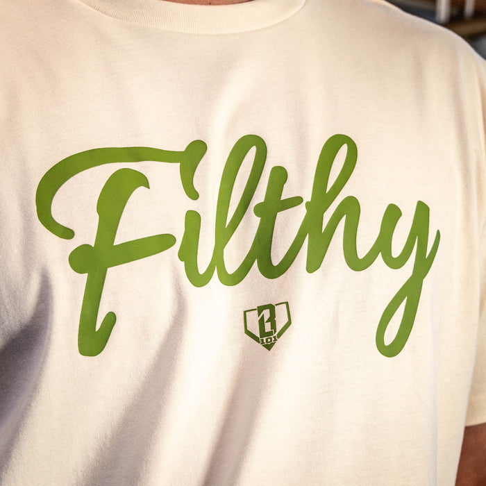 Close up of Youth Beige T-shirt with olive green ‘Filthy’ lettering and BL101 logo across chest.