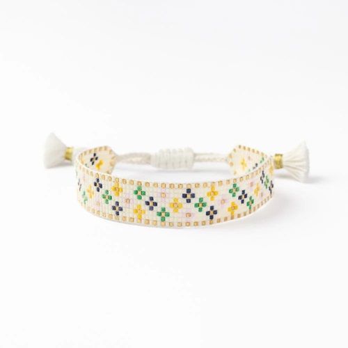 Ivory seed-bead bracelet with geometric floral motif and white tassel ties
