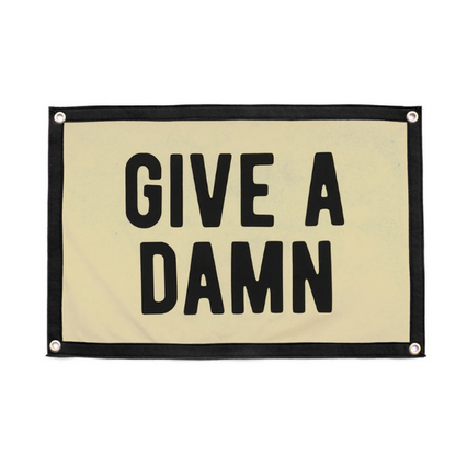 Rectangular camp flag with “GIVE A DAMN” lettering, light fabric and black trim