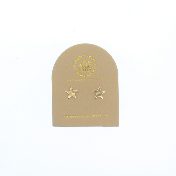 Gold star stud earrings on beige display card with two star studs