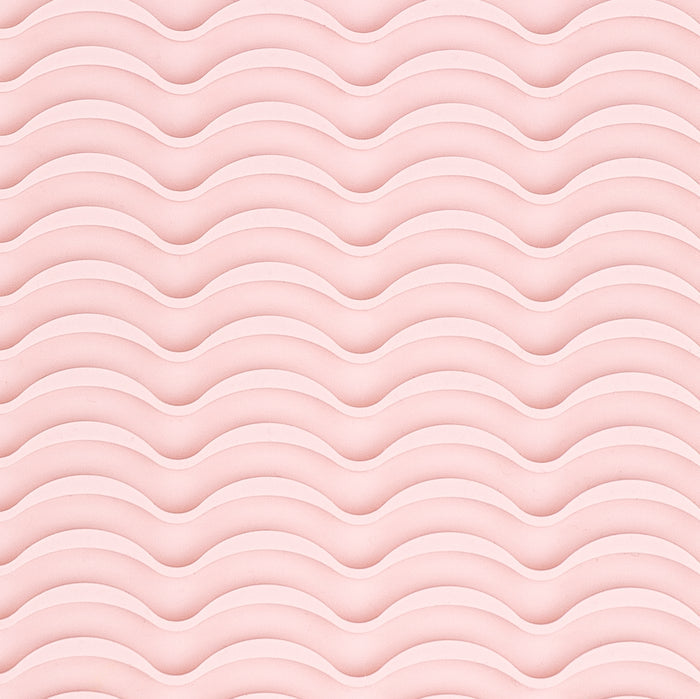 It shows a close-up of the silicone rippled surface of the styling tool heat-resistant mat.
