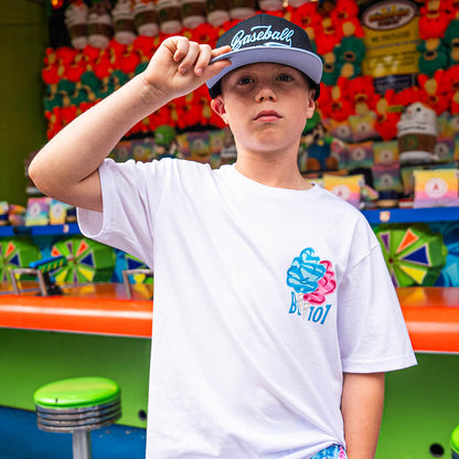 Child wearing a white t-shirt with pink and Blue cotton candy BL101 design and a baseball cap in front of a colorful background