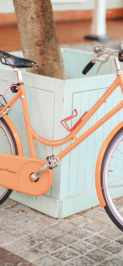 orange vintage bike and light blue misty phone background