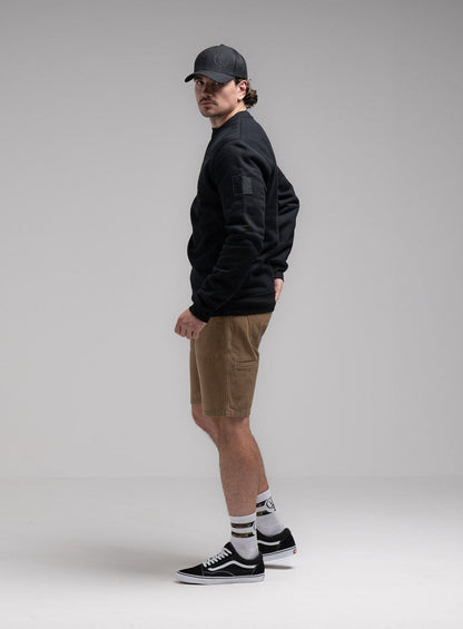 Jack Is 6ft 3" And Wears Size: L | Hem Studio Image Of Model Wearing Insignia Jumper - Black Mark In Obsidian Black (SS Model)