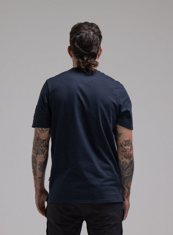 George Is 5ft 11" And Wears Size: S | Hem Studio Image Of Model Wearing Insignia T-Shirt G1 In Dark Sapphire (SS Model)