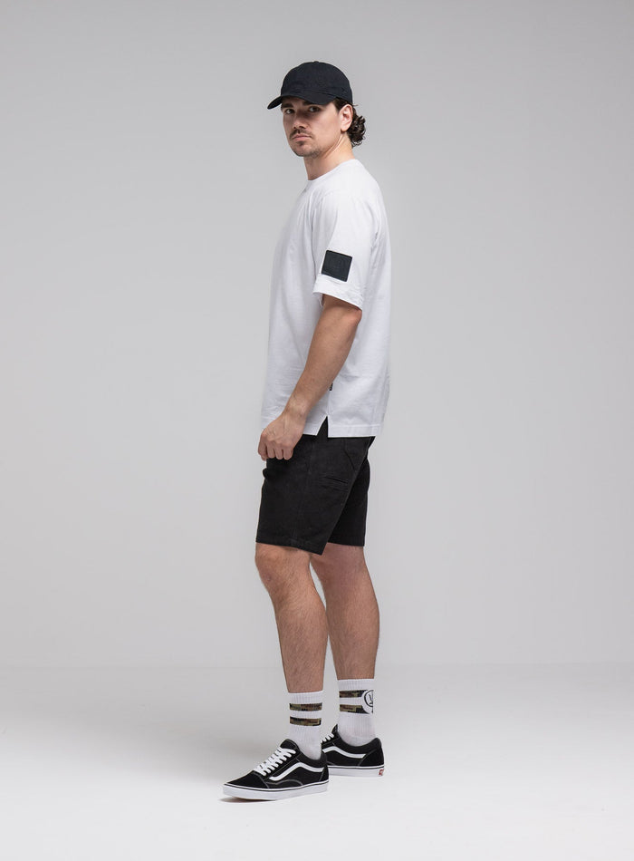 Jack Is 6ft 3" And Wears Size: L | Hem Studio Image Of Model Wearing Jackal T-Shirt In Optic White (SS Model)