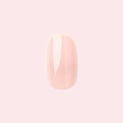 KAG - Press-On | Short | Round single neutral peachy pink false nail with glossy finish on light pink background