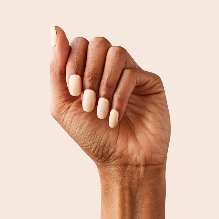 KAG - Press-On | Short | Round hand with neutral peachy pink short round false nails for a subtle manicure look