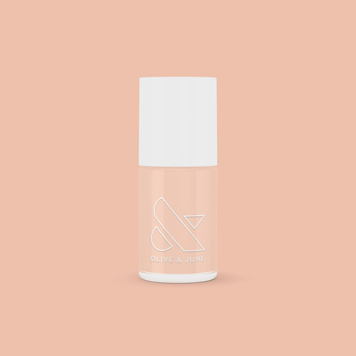 KAG nail polish bottle in neutral peachy pink shade on matching peach background for a fresh mani or pedi