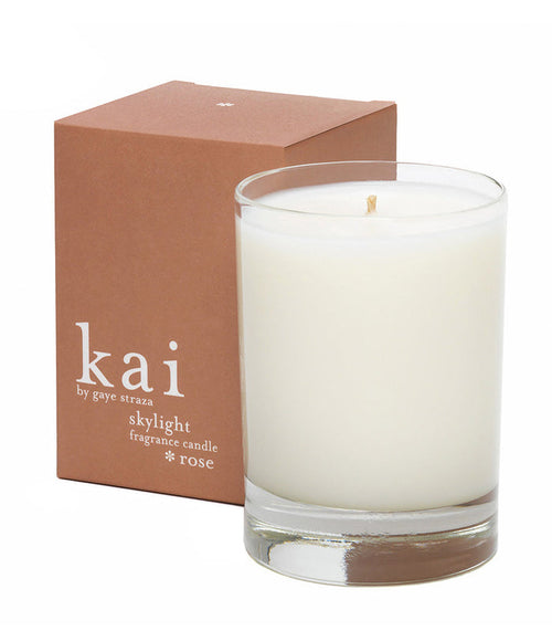White rose fragrance candle in clear glass tumbler, with small visible flame