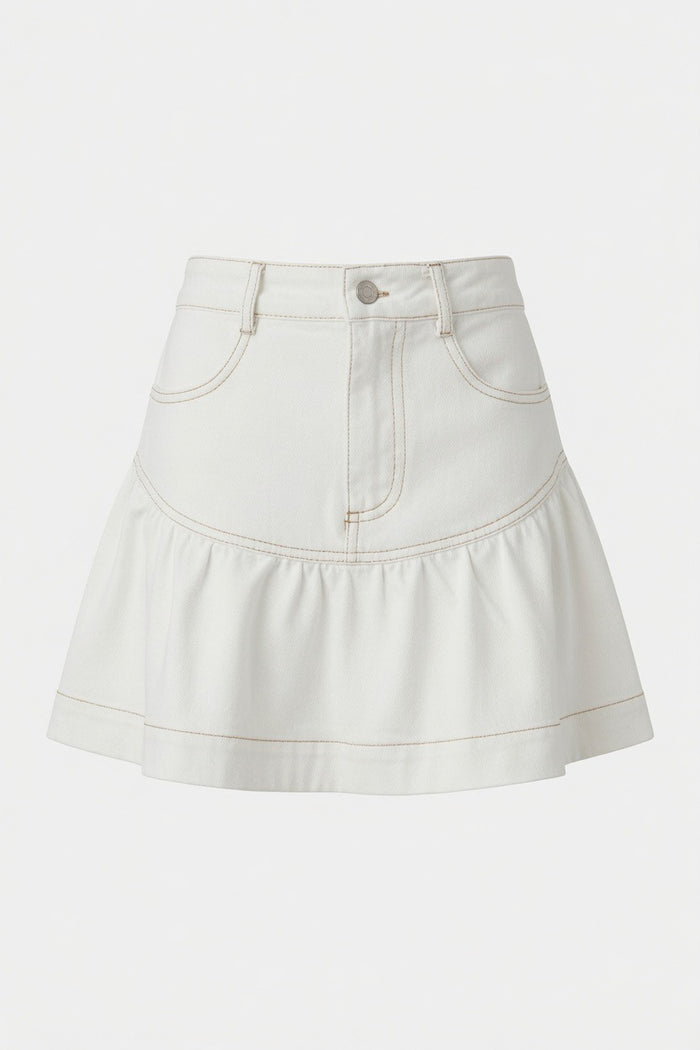 A close-up of a white denim mini skirt with a ruffled hem and contrast tan stitching