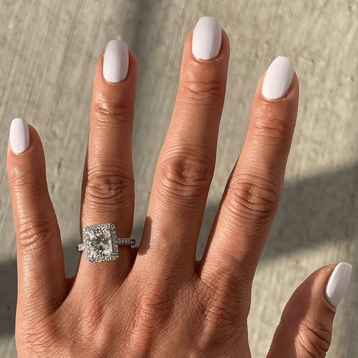 Hand with LHG polish in a fresh neutral shade on nails, featuring a smooth, long-lasting manicure in natural light
