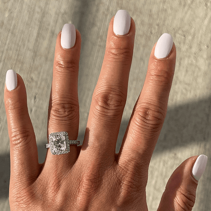 Hand with LHG polish in a fresh neutral shade on nails, featuring a smooth, long-lasting manicure in natural light
