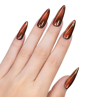 Hand with long, pointed nails painted with a brown nail polish on a white background