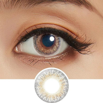 Close-up shot of model's eye adorned with Lilmoon Monthly Cream Grege (Prescription) color contact lenses prescription, paired with clean-girl eye makeup, showing the brightening and enlarging effect of the circle contact lens on dark brown eyes, above a cutout of the contact lens with limbal ring on a white background.