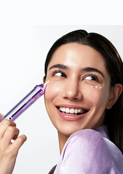 Woman applying a cosmetic product to her face with a white background