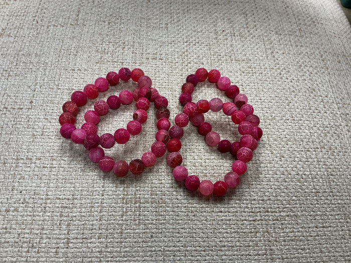 Pink glass beaded bracelet with round beads, stylish jewelry accessory from American Unique Group.